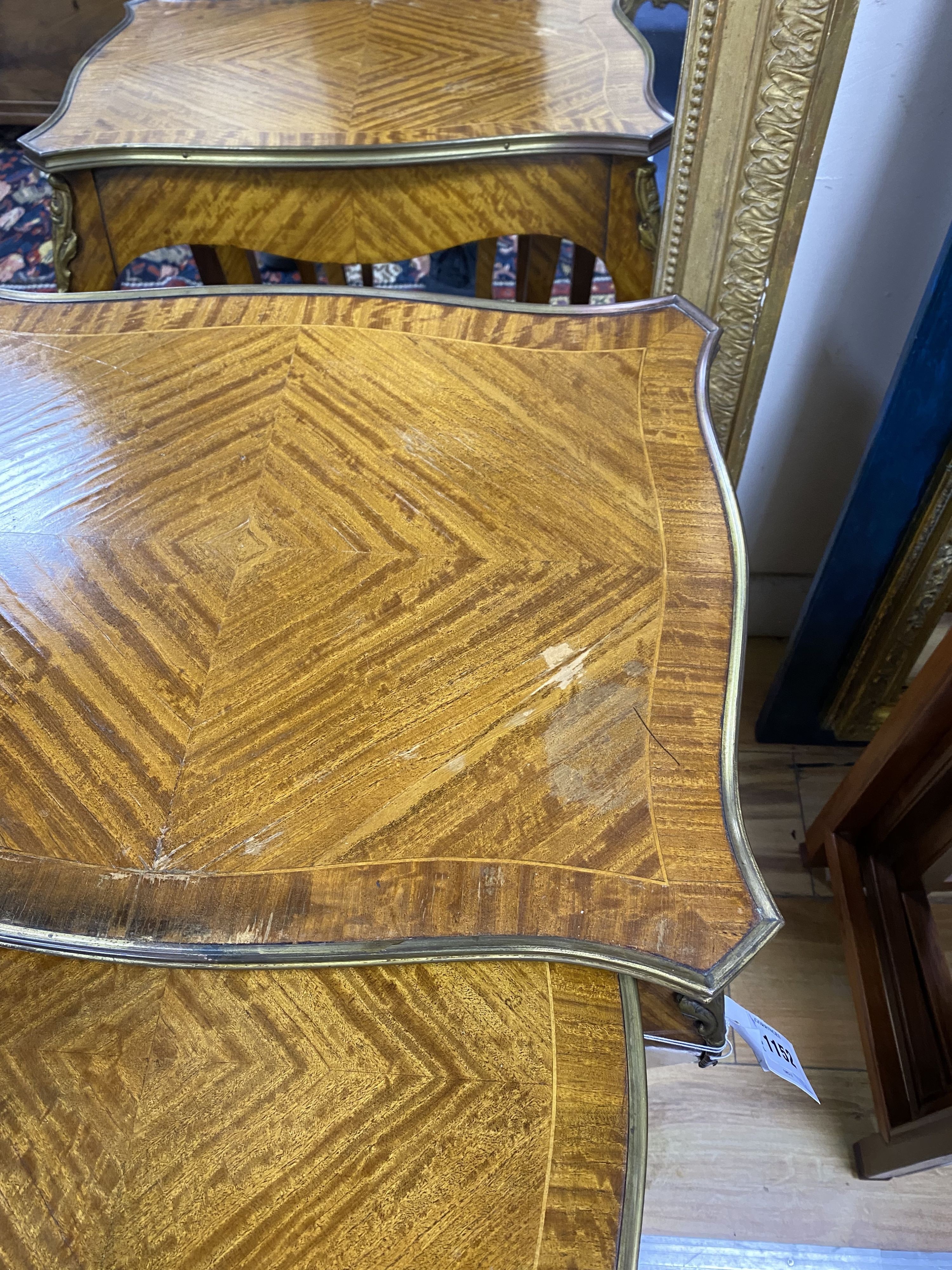 A nest of three Louis XV style ormolu mounted banded kingwood tables, with serpentine sides, on cabriole legs, width 51cm, depth 41cm, height 59cm